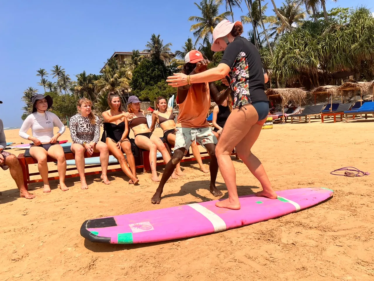 Surf guests together on the beach at Home Waves